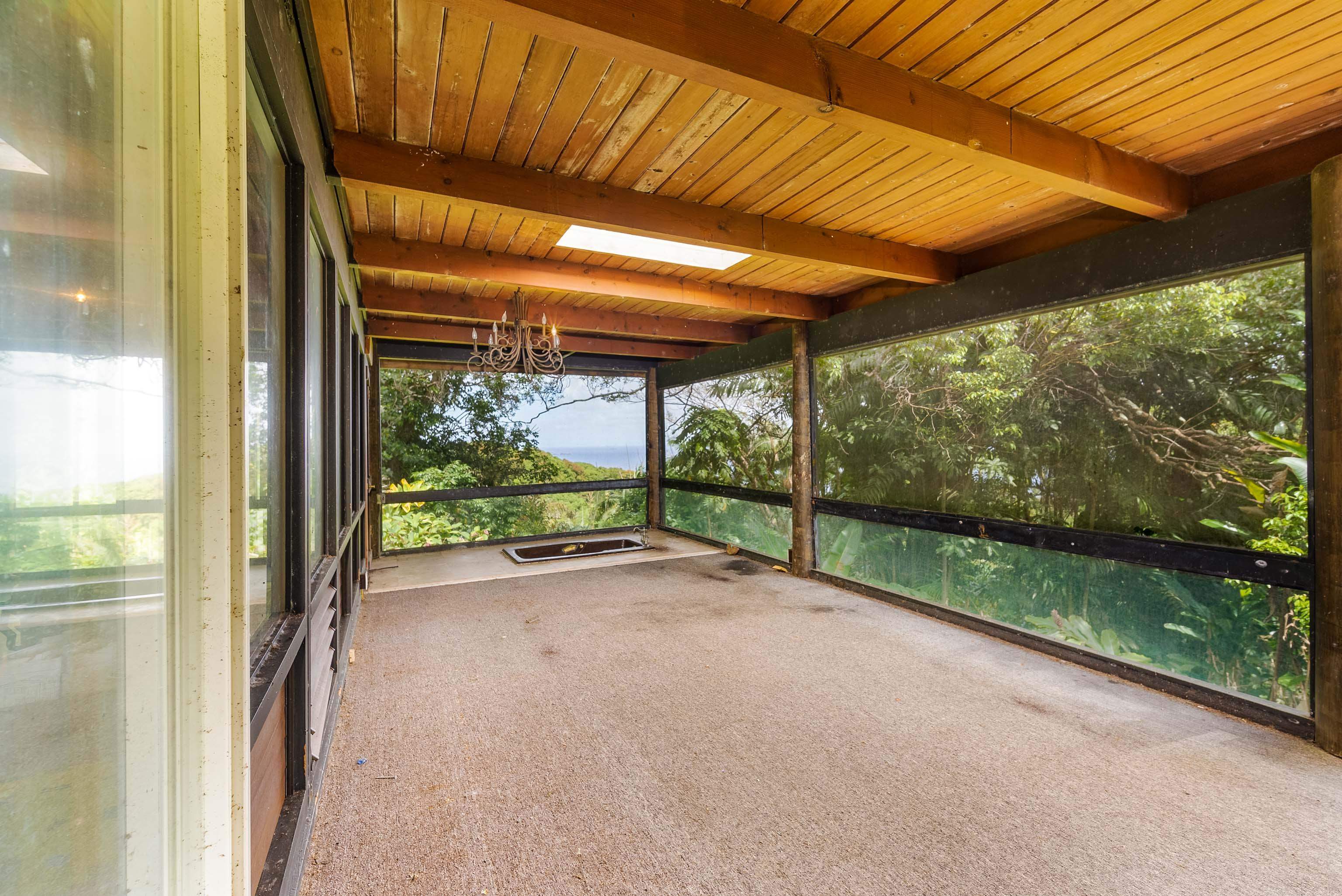 810 Nahiku Road Haiku, HI 96708 - Photo 13 of 50 a view of a room with wooden floor and outdoor space