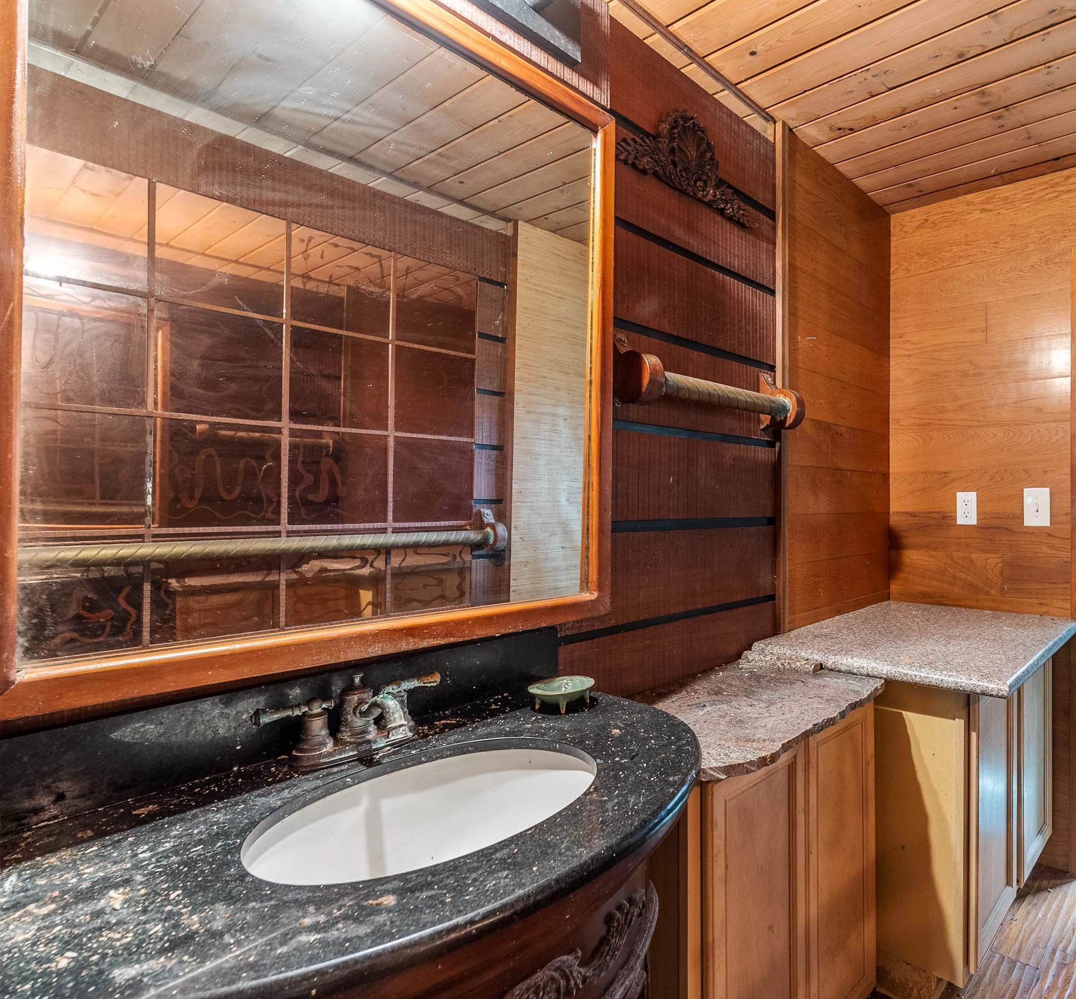 810 Nahiku Road Haiku, HI 96708 - Photo 17 of 50 a bathroom with a granite countertop sink and a mirror