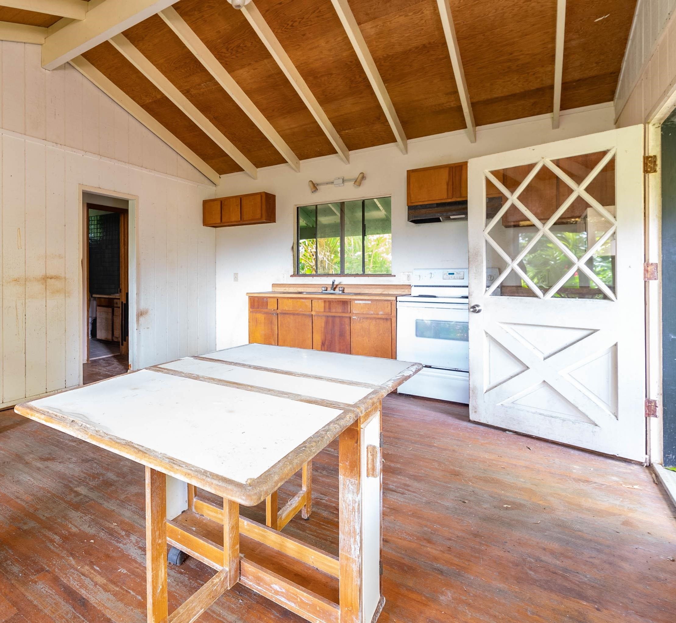 810 Nahiku Road Haiku, HI 96708 - Photo 42 of 50 a open kitchen with stainless steel appliances wooden floors and wooden cabinets