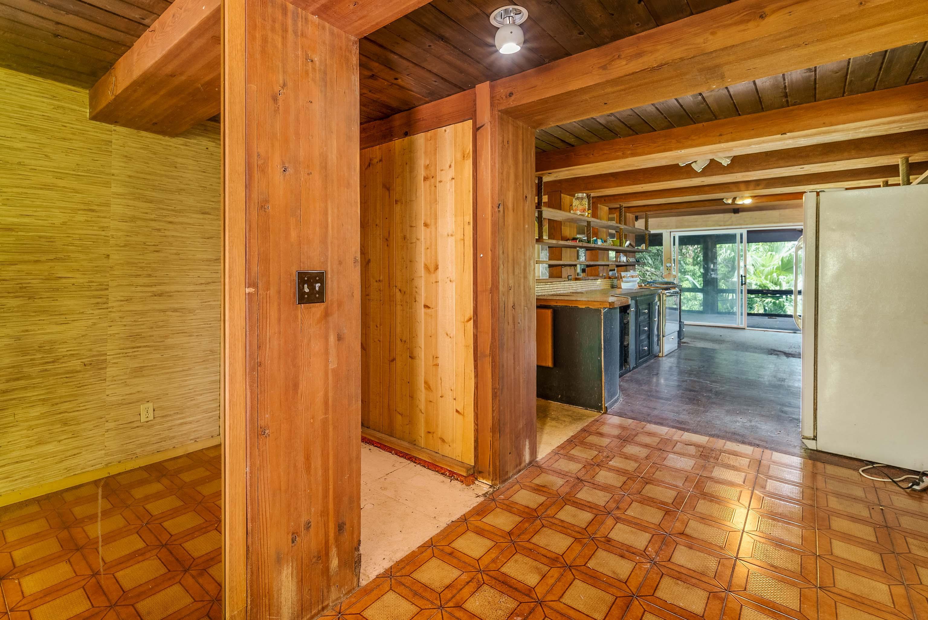 810 Nahiku Road Haiku, HI 96708 - Photo 9 of 50 a view of a hallway with wooden floor and furniture