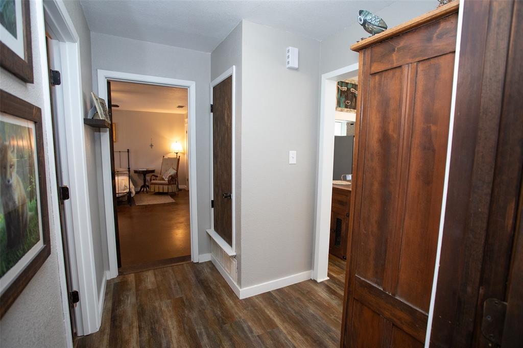 1250 Canyon Road Graham, TX 76450 - Photo 11 of 40 a view of a hallway with a livingroom and a bathroom
