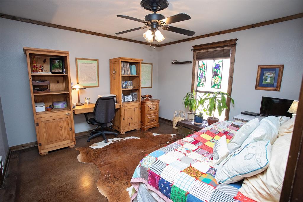 1250 Canyon Road Graham, TX 76450 - Photo 13 of 40 a bed room with a bed and a chandelier