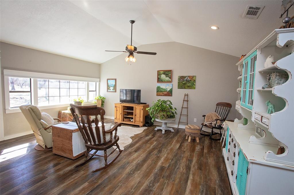 1250 Canyon Road Graham, TX 76450 - Photo 17 of 40 a living room with furniture a flat screen tv and wooden floor