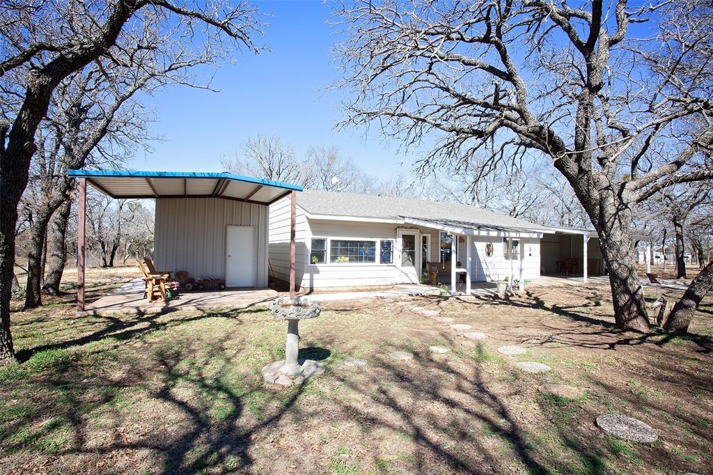 1250 Canyon Road Graham, TX 76450 - Photo 2 of 40 a front view of house with yard outdoor seating and barbeque oven