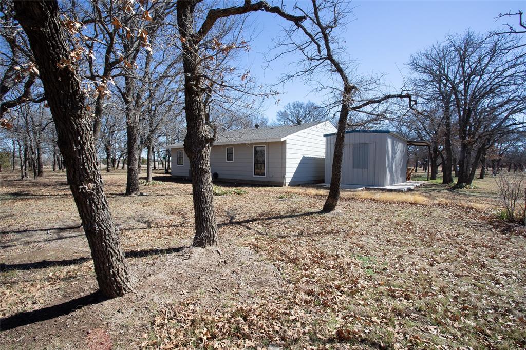 1250 Canyon Road Graham, TX 76450 - Photo 4 of 40 a view of a house with a yard covered in snow