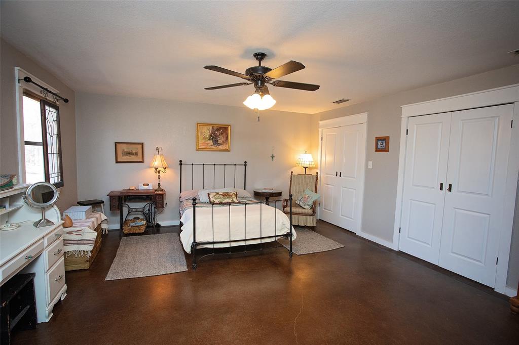 1250 Canyon Road Graham, TX 76450 - Photo 6 of 40 a bed room with a bed and a chandelier