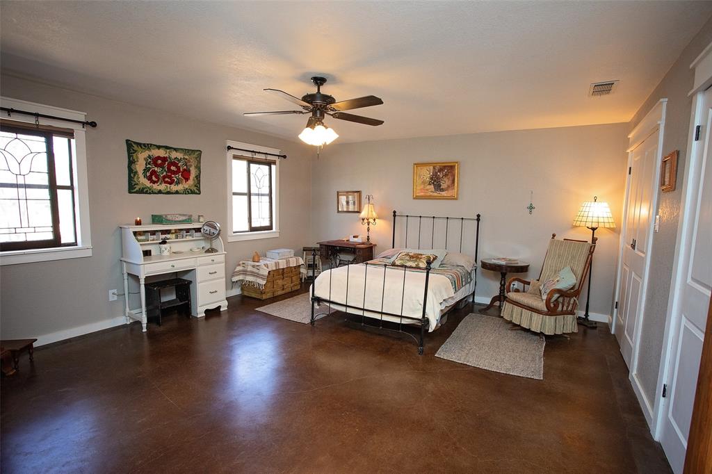 1250 Canyon Road Graham, TX 76450 - Photo 7 of 40 a spacious bedroom with a bed couch and a window