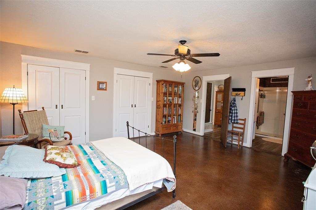1250 Canyon Road Graham, TX 76450 - Photo 8 of 40 a bedroom with a bed and wooden floor