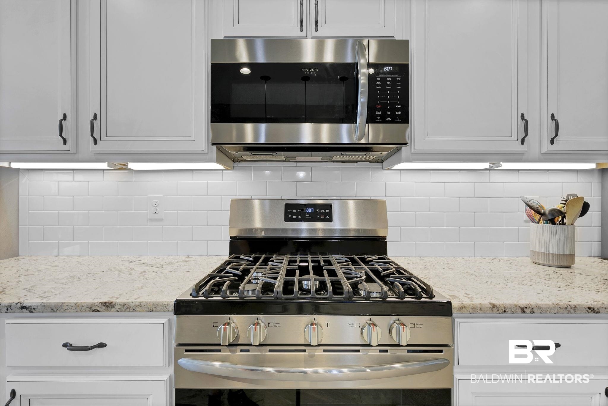 11247 Thistledown Loop Spanish Fort, AL 36527 - Photo 18 of 72 Kitchen featuring white cabinets, appliances with stainless steel finishes, light stone counters, and decorative backsplash