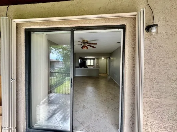 a view of a hallway with wooden shelves