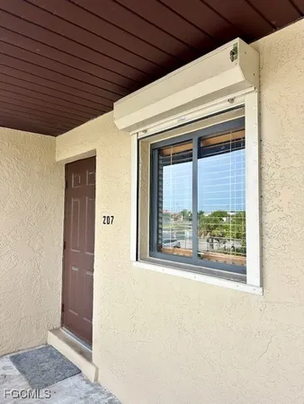a front view of a house with a large window