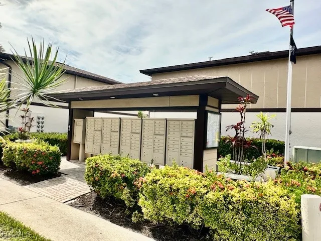 a couple of flower plants in front of building