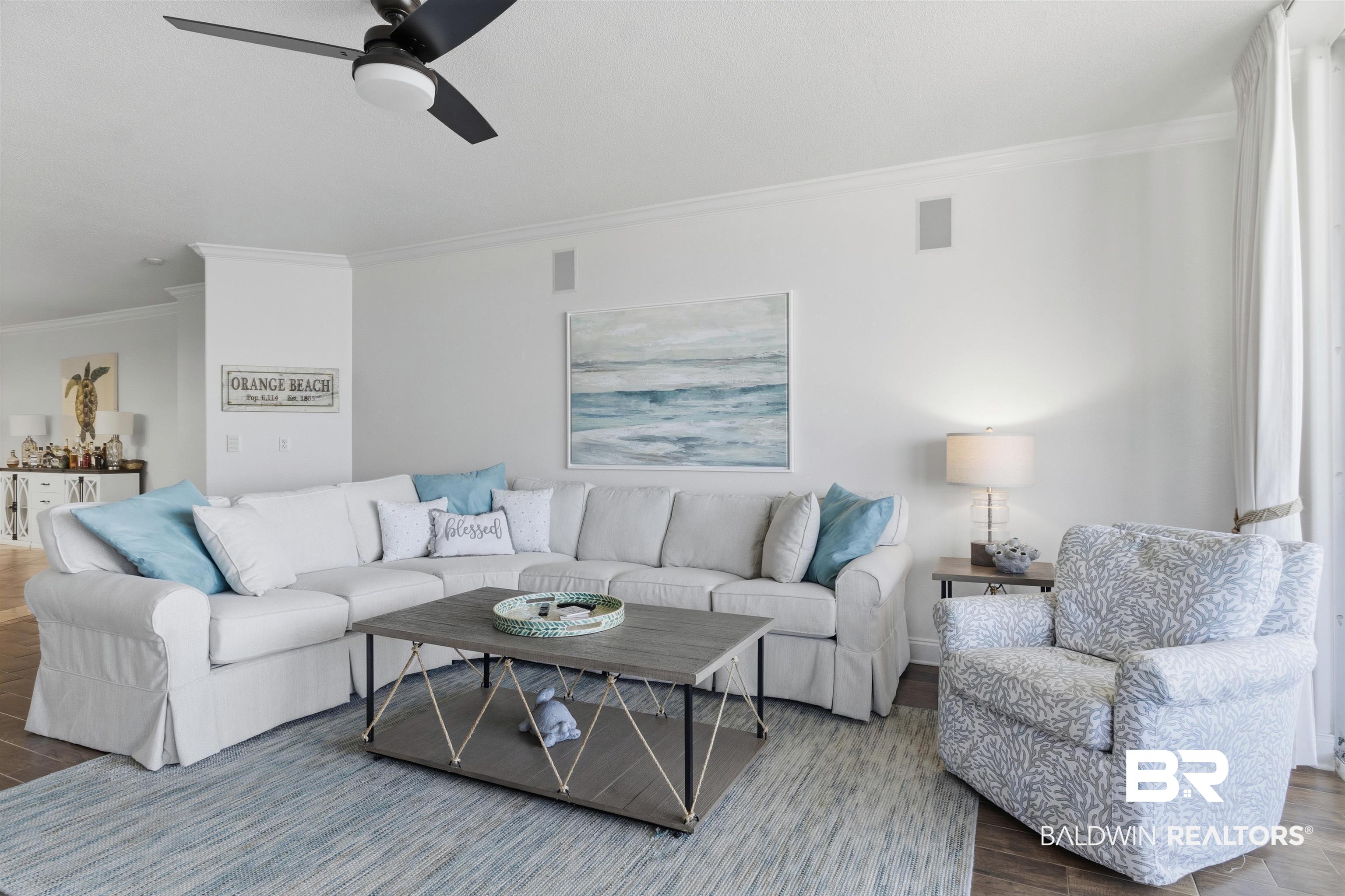 3564 Bayou Road, Unit 203 Orange Beach, AL 36561 - Photo 20 of 53 White-painted walls with crown molding and wood-finish flooring define this living area