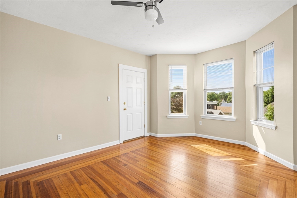 18 St Clair Street, Unit 3 Lynn, MA 01902 - Photo 12 of 36 a view of empty room with wooden floor and fan
