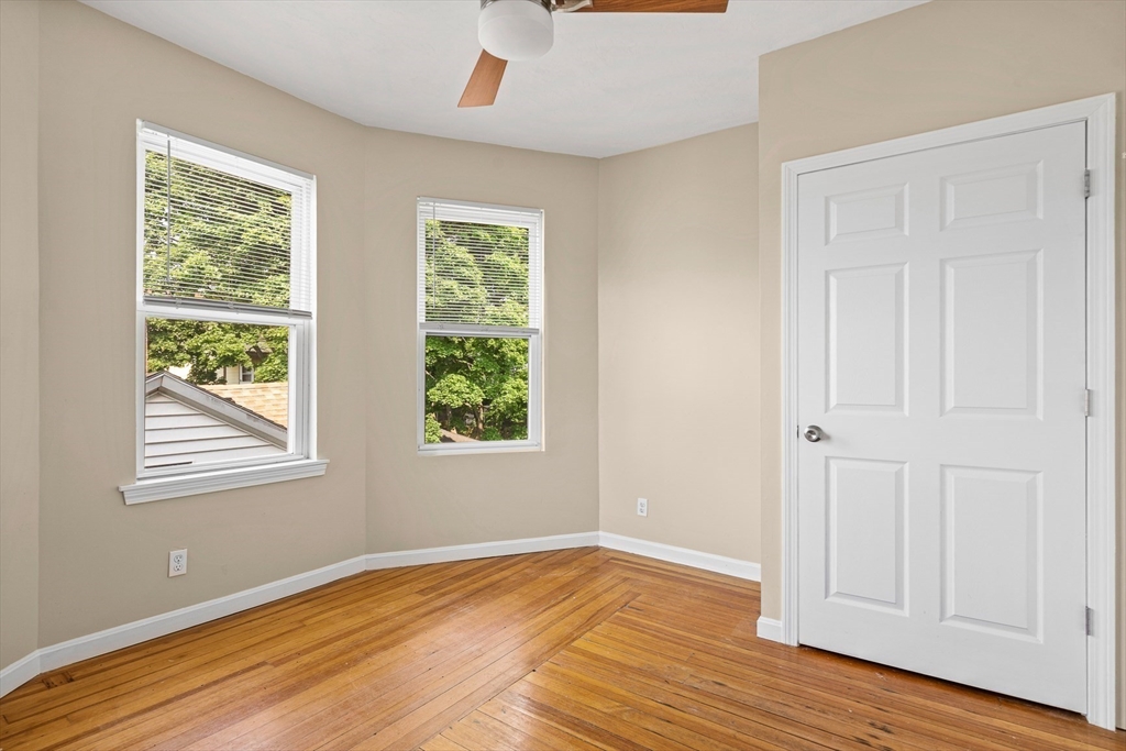 18 St Clair Street, Unit 3 Lynn, MA 01902 - Photo 15 of 36 a view of an empty room with wooden floor and a window