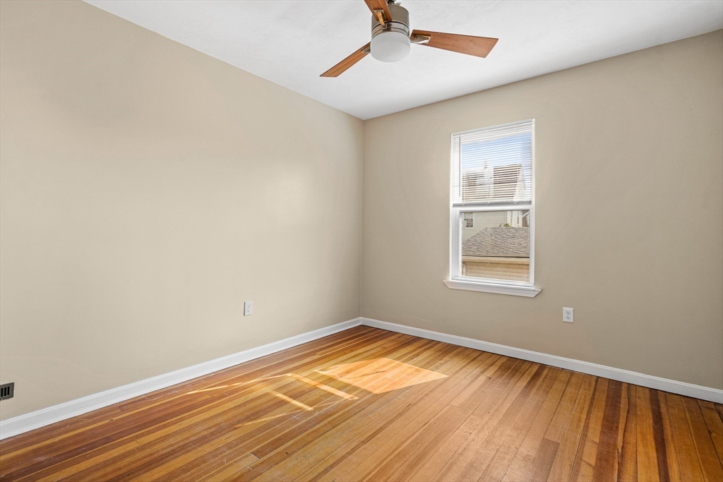 18 St Clair Street, Unit 3 Lynn, MA 01902 - Photo 17 of 36 wooden floor in an empty room with a window
