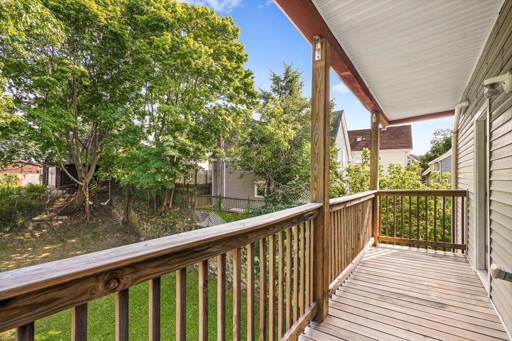 18 St Clair Street, Unit 3 Lynn, MA 01902 - Photo 4 of 36 a view of a wooden deck next to a lake view