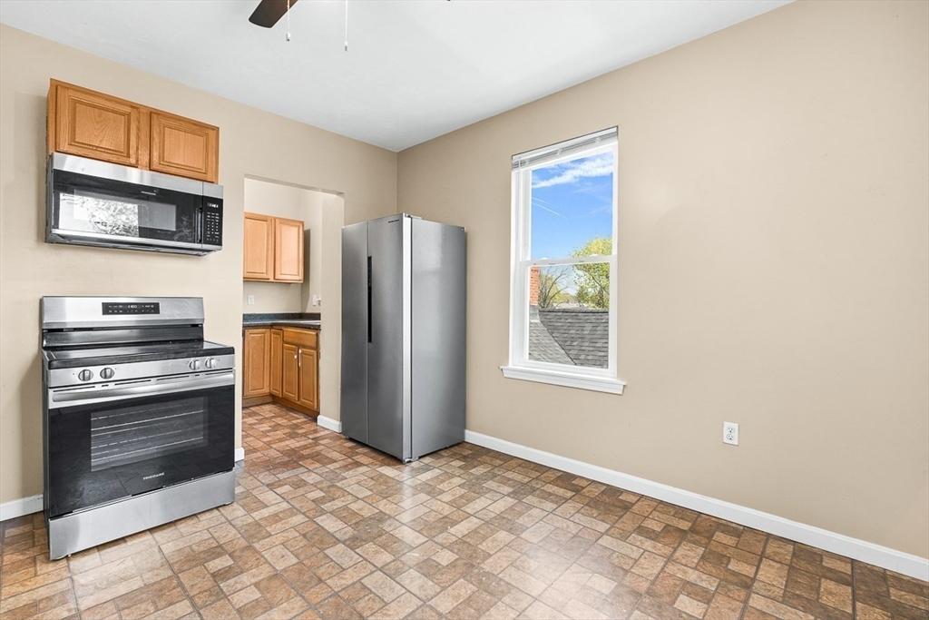 18 St Clair Street, Unit 3 Lynn, MA 01902 - Photo 8 of 36 a kitchen with a refrigerator and a stove top oven