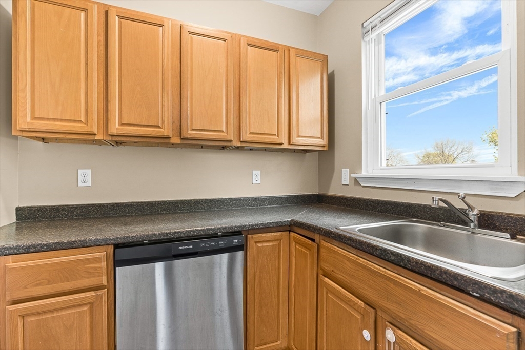 18 St Clair Street, Unit 3 Lynn, MA 01902 - Photo 9 of 36 a kitchen with granite countertop a sink and a white cabinets