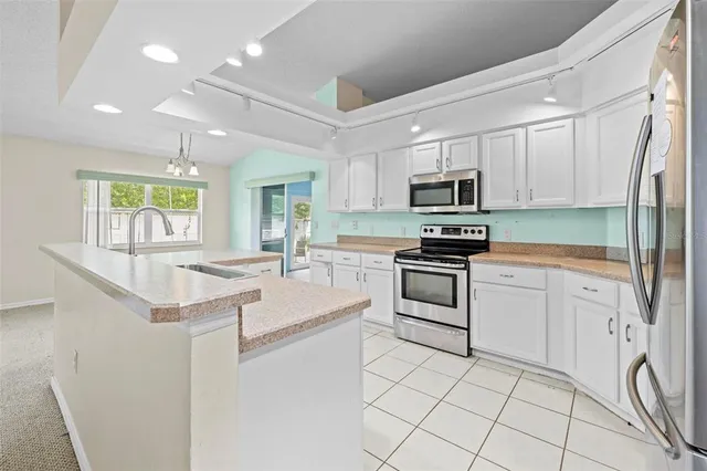 a kitchen with a sink cabinets and window
