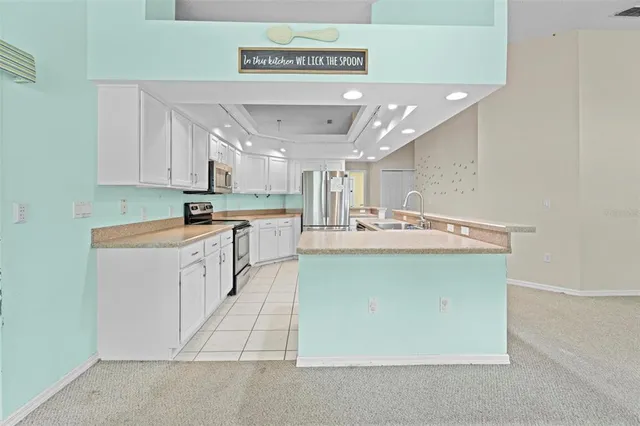 a kitchen with stainless steel appliances a refrigerator sink and cabinets