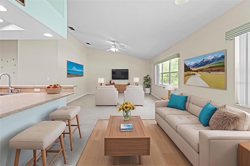 7492 Aloe Drive Spring Hill, FL 34607 - Photo 16 of 57 a living room with furniture and a flat screen tv