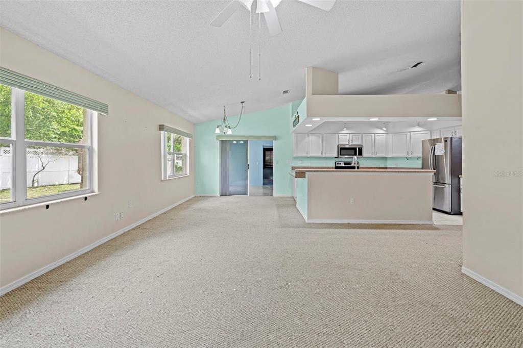 7492 Aloe Drive Spring Hill, FL 34607 - Photo 20 of 57 a view of a kitchen with kitchen island wooden floor and stainless steel appliances
