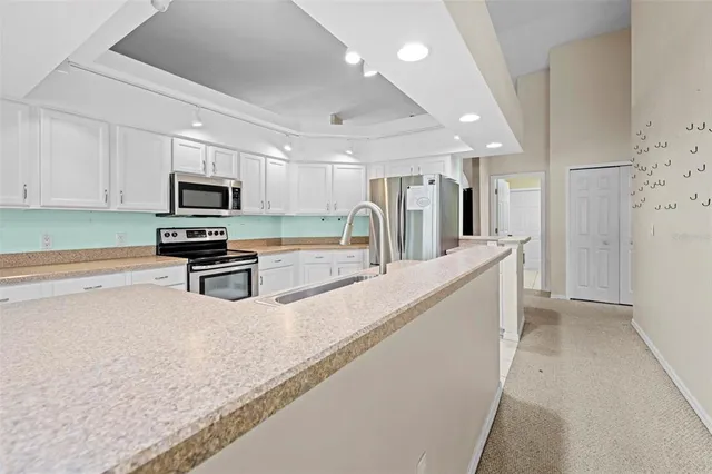 a view of hallway with a ceiling fan