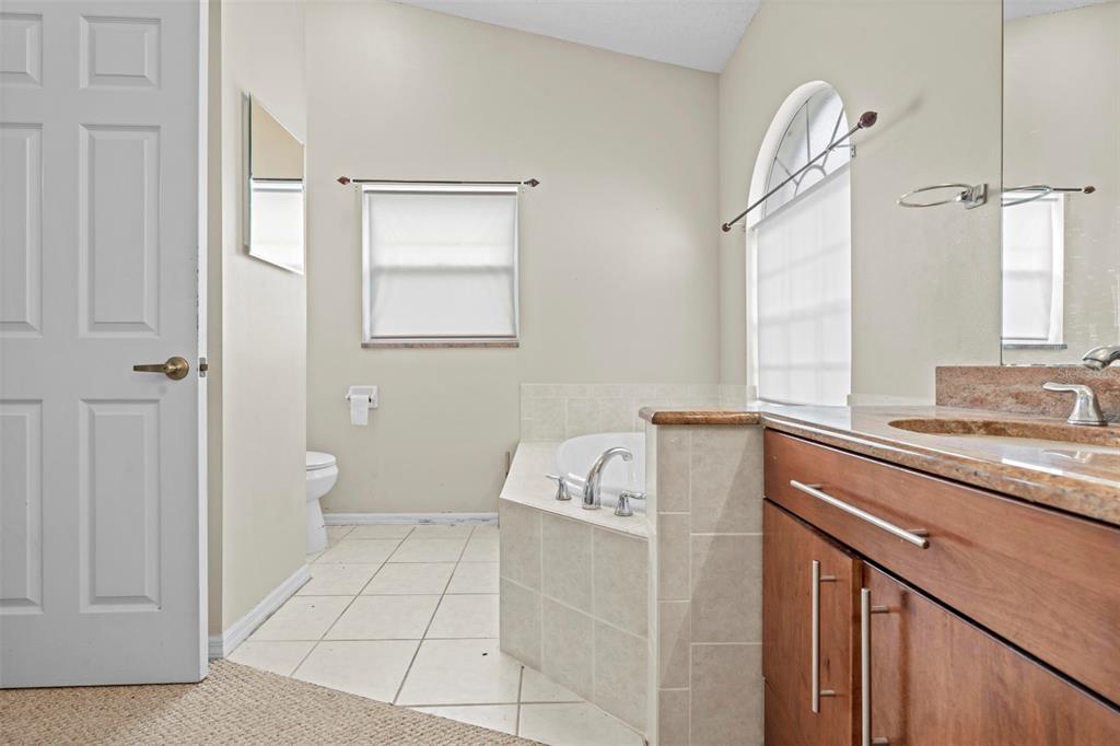 7492 Aloe Drive Spring Hill, FL 34607 - Photo 33 of 57 a bathroom with a sink a toilet and a window