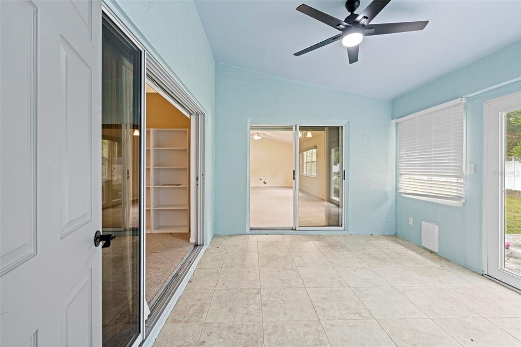 7492 Aloe Drive Spring Hill, FL 34607 - Photo 39 of 57 a view of a room with a ceiling fan and windows