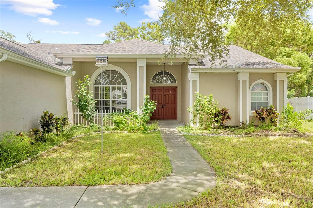 7492 Aloe Drive Spring Hill, FL 34607 - Photo 4 of 57 a front view of a house with garden