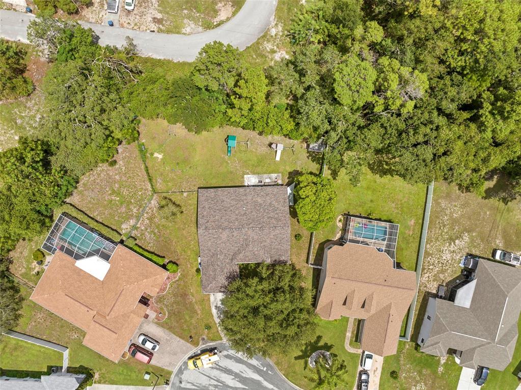 7492 Aloe Drive Spring Hill, FL 34607 - Photo 44 of 57 an aerial view of a house with a yard and trees