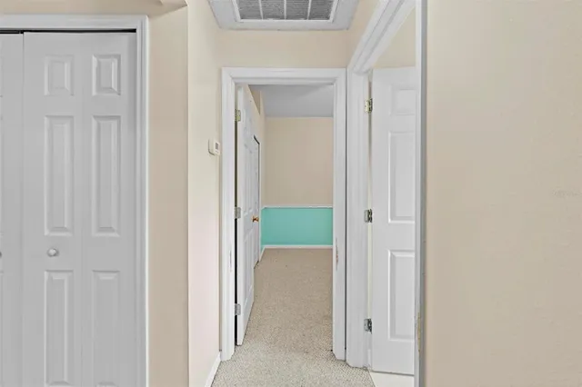 a utility room with a sink a cabinetry and a refrigerator