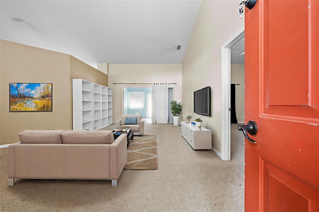 7492 Aloe Drive Spring Hill, FL 34607 - Photo 5 of 57 a living room with furniture and a flat screen tv