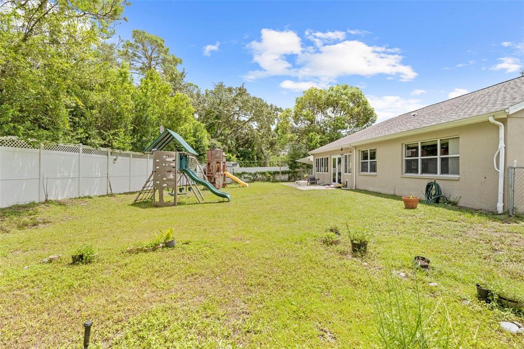 7492 Aloe Drive Spring Hill, FL 34607 - Photo 55 of 57 a view of a swimming pool with some potted plants by side of it