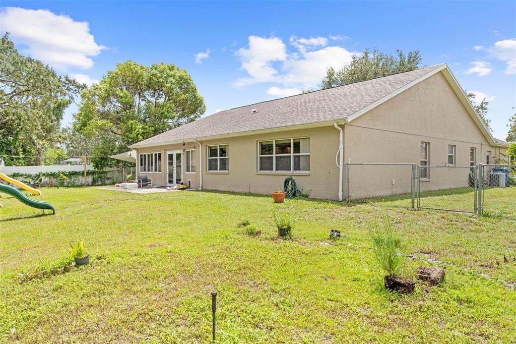 7492 Aloe Drive Spring Hill, FL 34607 - Photo 56 of 57 a view of a house with pool and a yard