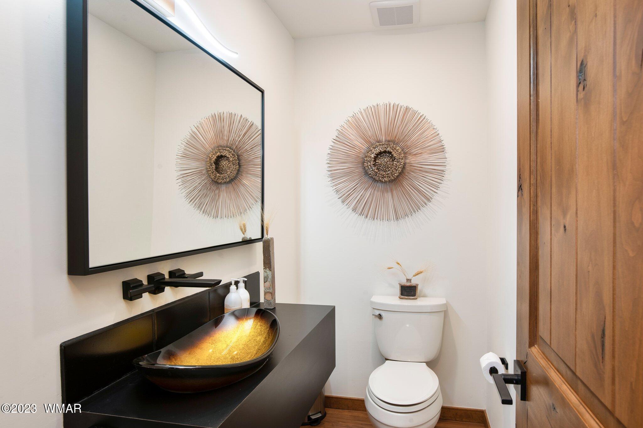 1591 South Falling Leaf Road Show Low, AZ 85901 - Photo 22 of 56 Stylish powder room with floating vanity.