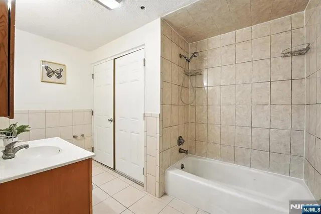 a bathroom with a sink mirror toilet and bathtub