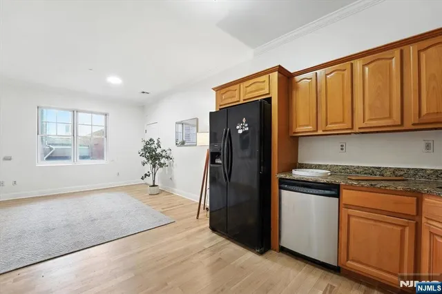 a kitchen with stainless steel appliances granite countertop a refrigerator and cabinets