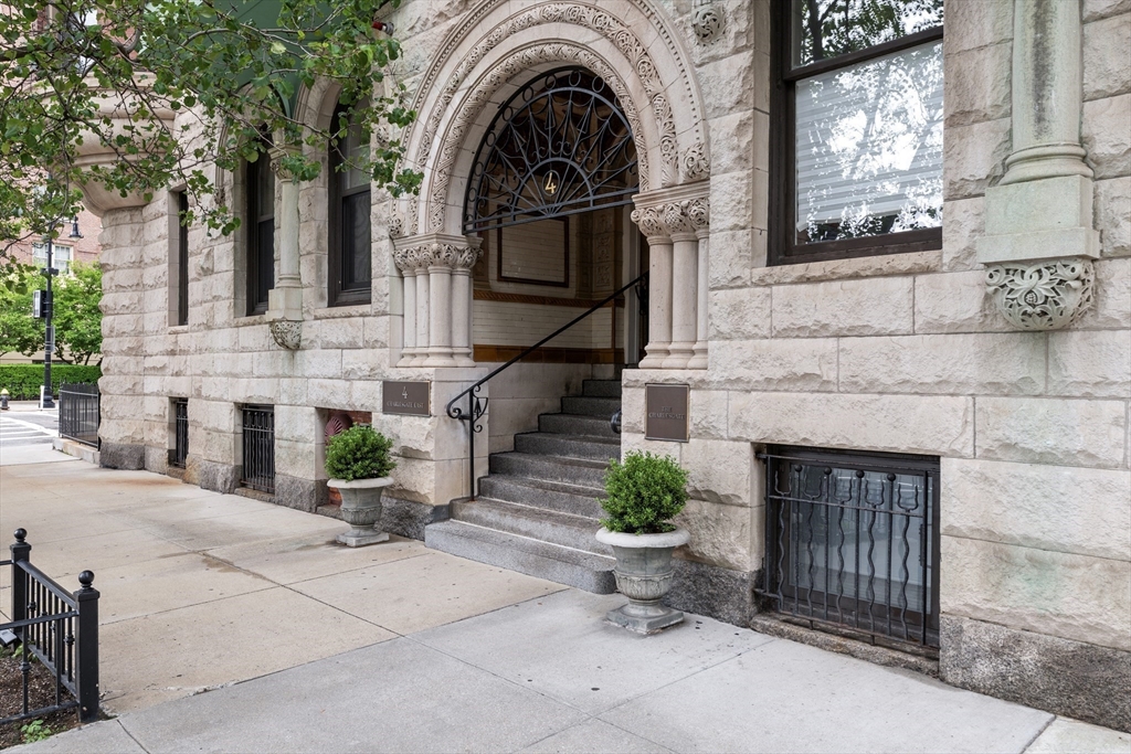 4 Charlesgate East, Unit 606 Boston, MA 02215 - Photo 25 of 25 a view of a brick house with potted plants and a large tree