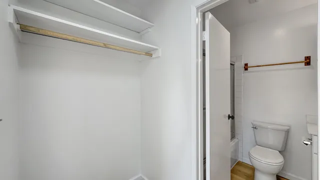 a view of an empty room and wooden floor