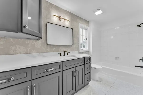 a kitchen with stainless steel appliances granite countertop a refrigerator a sink dishwasher a s stove top oven a large island with wooden cabinets and floor