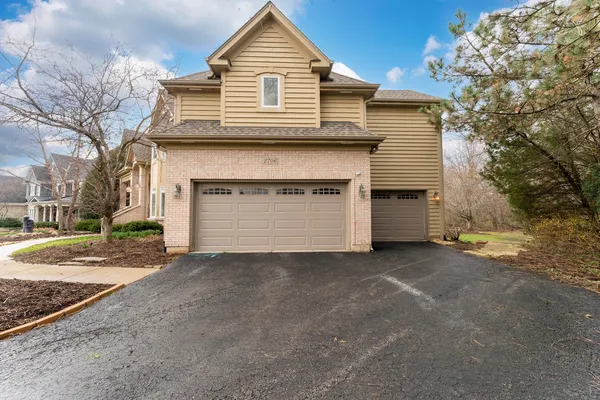a view of a house with a yard and garage