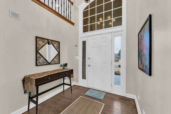 a view of an entryway with wooden floor and door