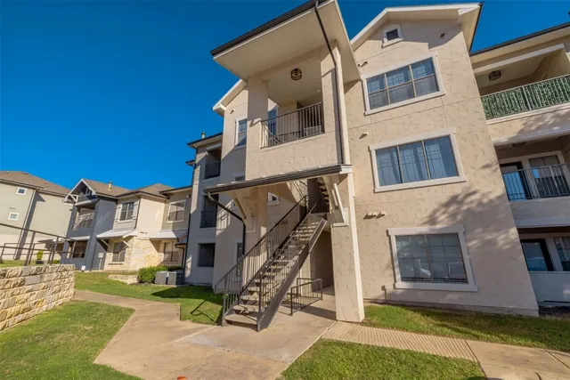 a view of a white building with many windows
