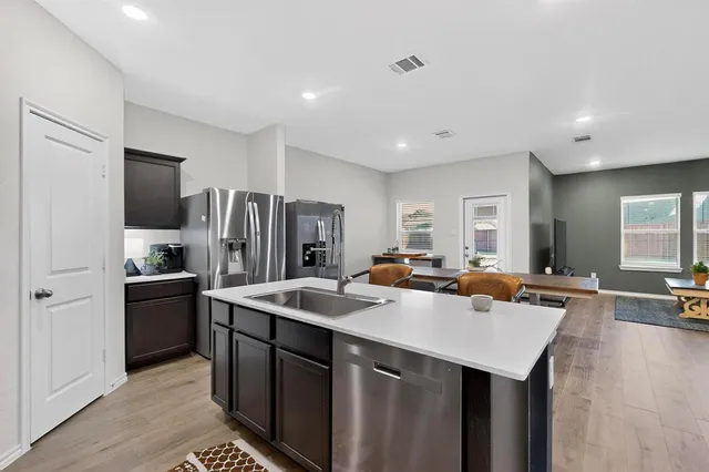 a kitchen that has a sink and a refrigerator