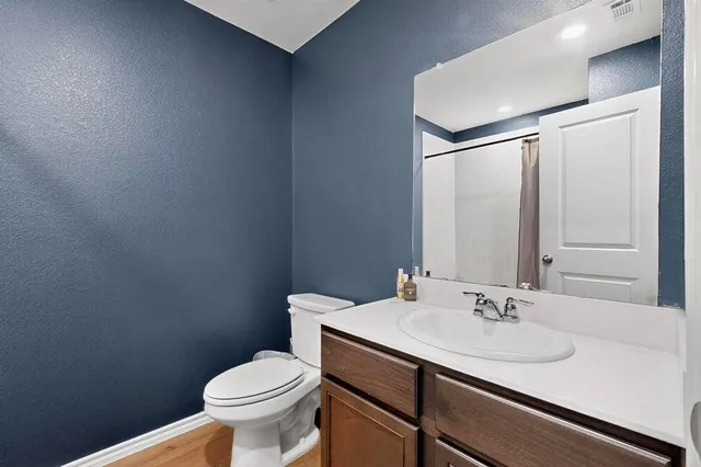a bathroom with a sink toilet and a mirror