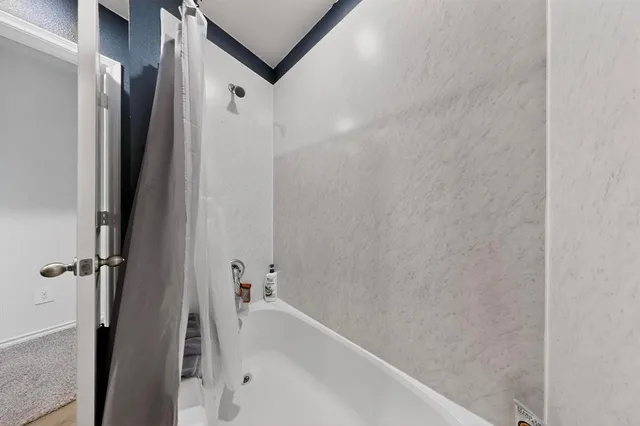 a bathroom with a bathtub and shower