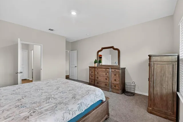 a bedroom with a bed and a dresser