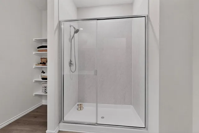 a bathroom with a glass shower door